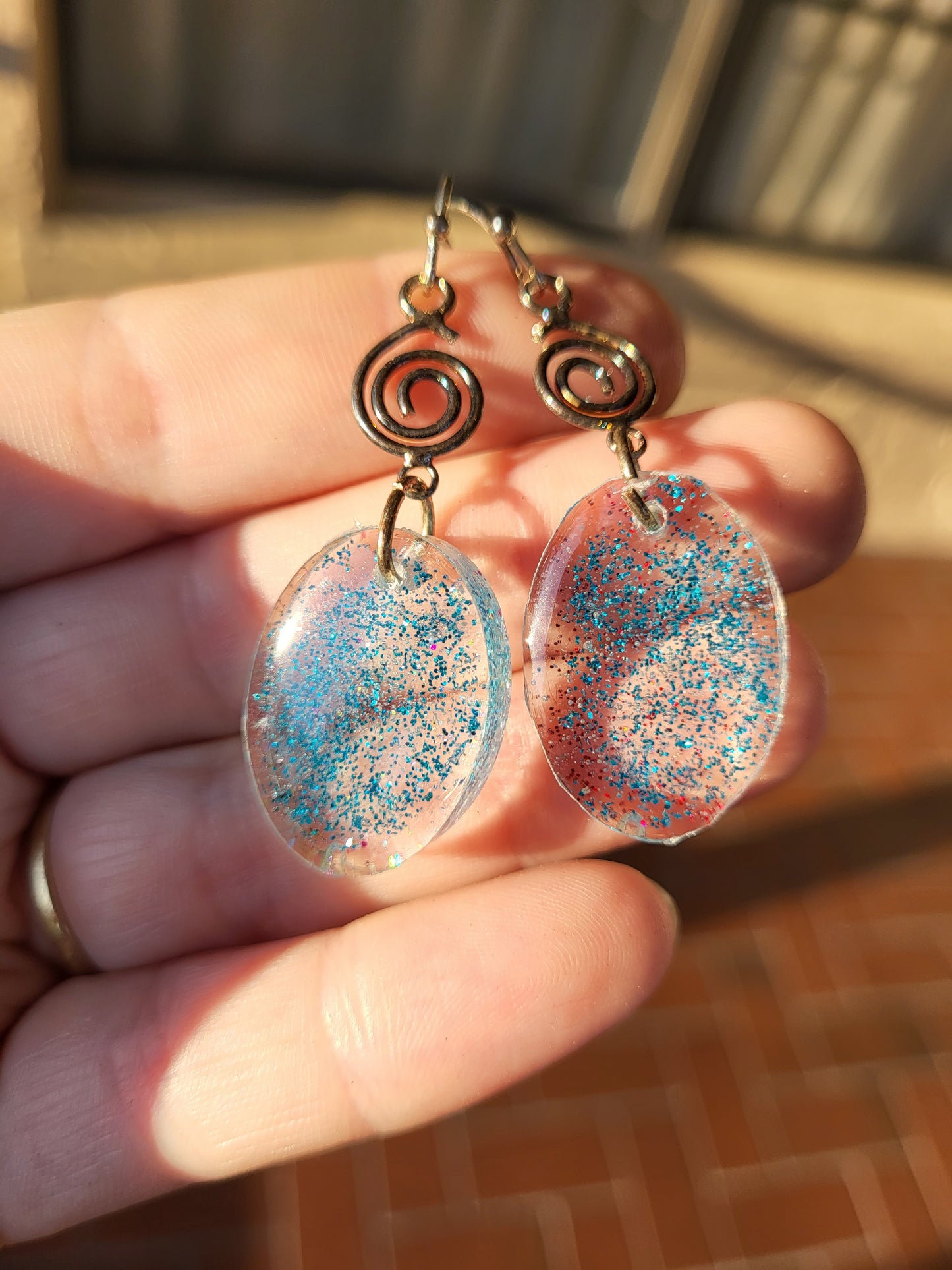 Blue Resin Oval Hook Earrings With Swirl Charm