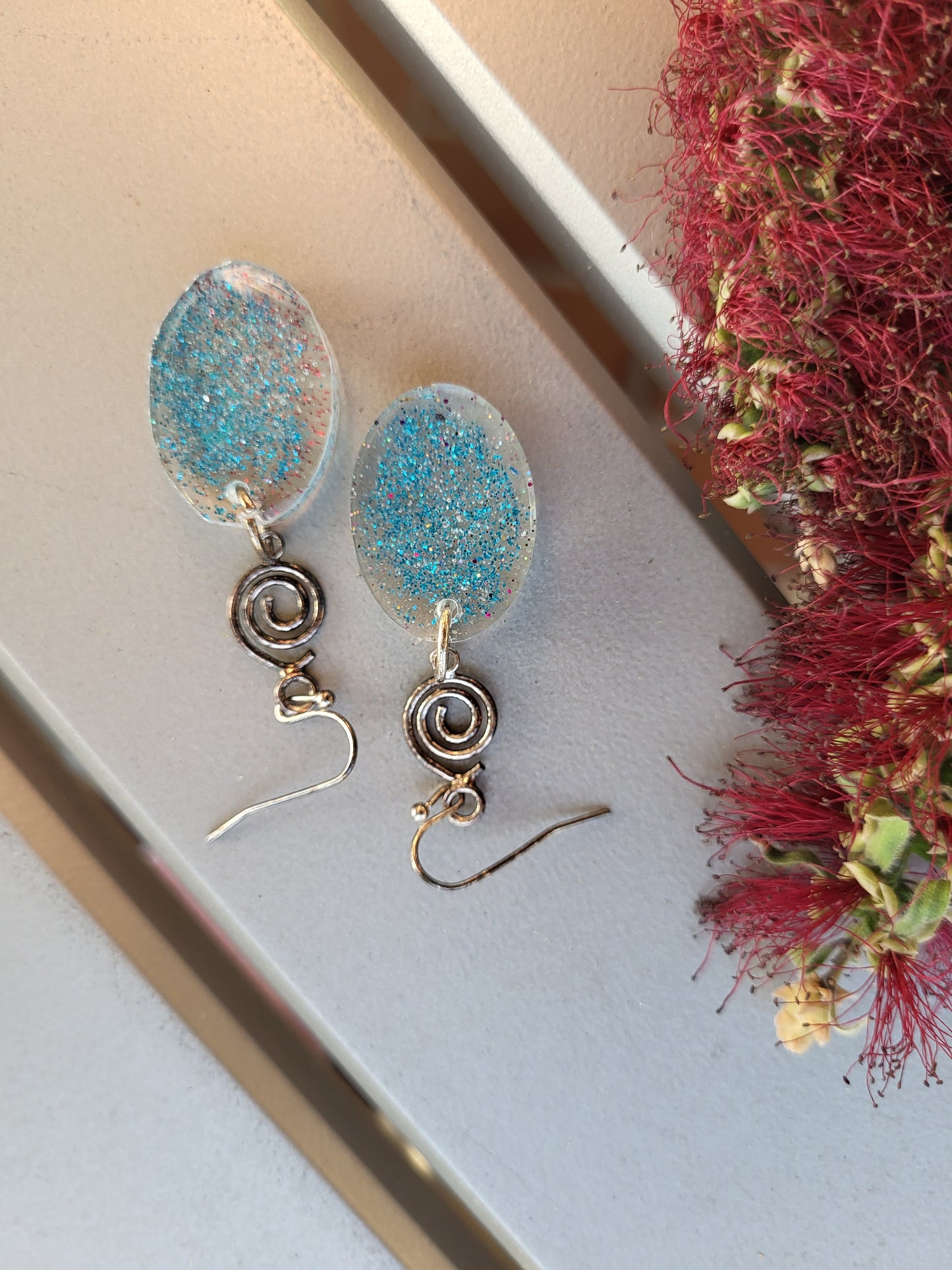 Blue Resin Oval Hook Earrings With Swirl Charm